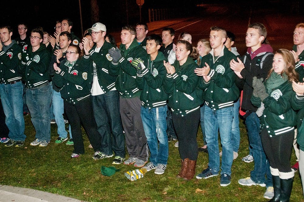 <p>The MSU Marching Band sings the fight song on Oct. 22, 2014, at the Spartan Statue. The band came out to show support for Sparty Watch. Raymond Williams/The State News</p>