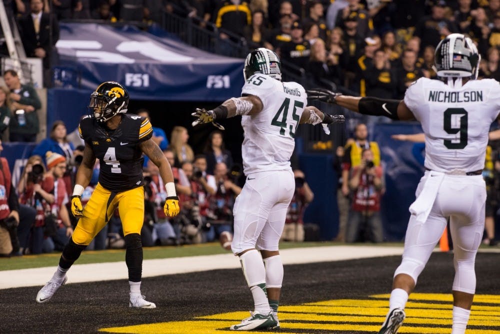 Senior linebacker Darien Harris, 45, and sophomore safety Montae Nicholson, 9, motion that the intended pass was incomplete to Iowa wide receiver Jerminic Smith during the first quarter on Dec. 5, 2015 at the Big Ten championship game against Iowa at Lucas Oil Stadium in Indianapolis. The Spartans defeated the Hawkeyes, 16-13.