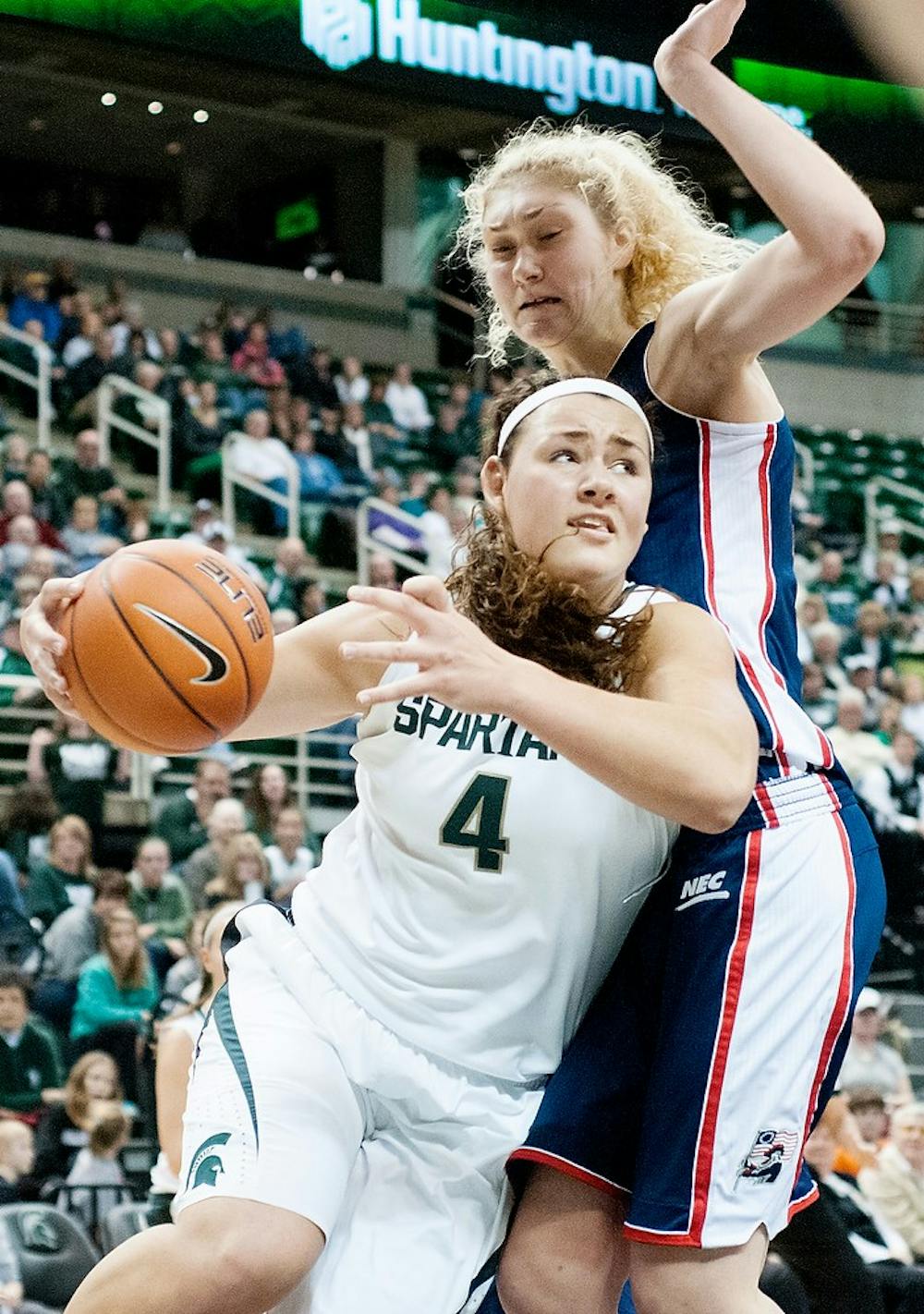 	<p>Sophomore center Jasmine Hines goes for a layup while pushing aside Robert Morris forward Anna Gailite on Sunday, Nov. 25, 2012, at Breslin Center. The Spartans defeated the Colonials 68-35. Julia Nagy/The State News</p>