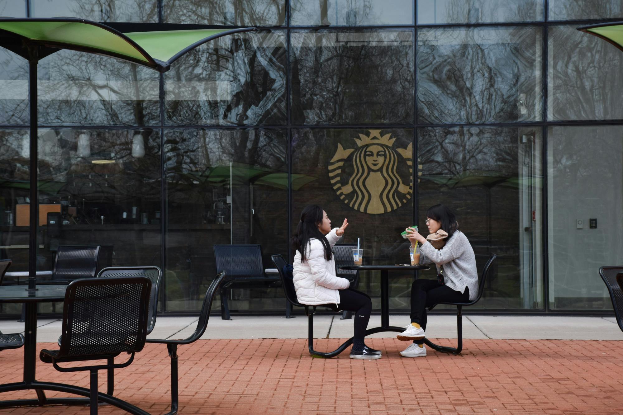 <p>Two MSU students outside of the Starbucks located in Wells Hall on April 5, 2022.</p>