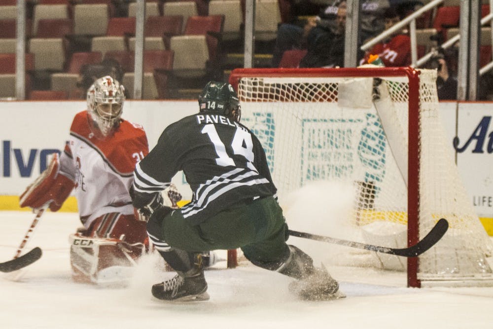 Junior forward Dylan Pavelek (14) scores on Ohio State goaltender Matt Tomkins (31) during the first period of the men’s hockey game against Ohio State University on March 16, 2017 at Joe Louis Arena in Detroit. The spartans are up, 3-2. 