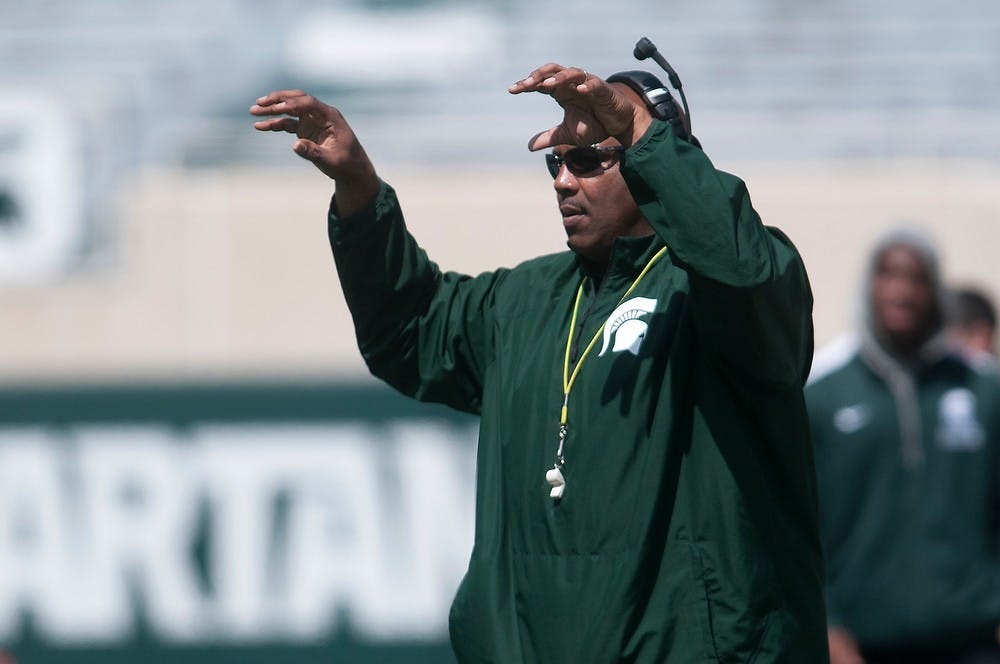 <p>Head coach of the White team Ron Burton motions to his team April 26, 2014, during the Spring Green and White game at Spartan Stadium. The White team won, 20-13. Julia Nagy/The State News</p>