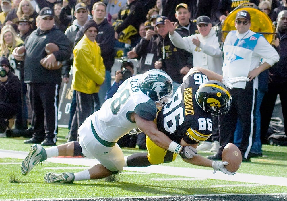 	<p>Then-sophomore Denicos Allen tackles Iowa tight end C.J. Fiedorowicz in a 2011 game. With the Hawkeyes coming to East Lansing, the Spartans can’t overlook them with the U-M game looming. State News File Photo</p>