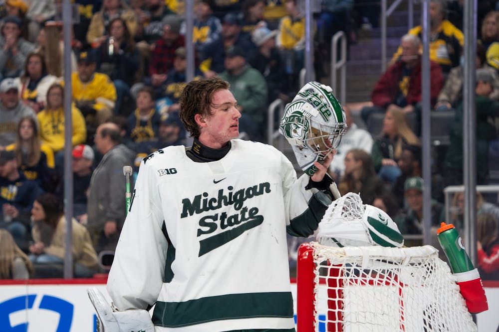 <p>Michigan State goaltender Trey Augustine inspects his mask before gearing back up at Little Caesars Arena on Saturday, Feb. 10, 2024, for the "Duel in the D." The 18-year-old Michigan native was drafted by the Detroit Red Wings in 2023 and has been extremely solid between the posts for MSU this season.</p>