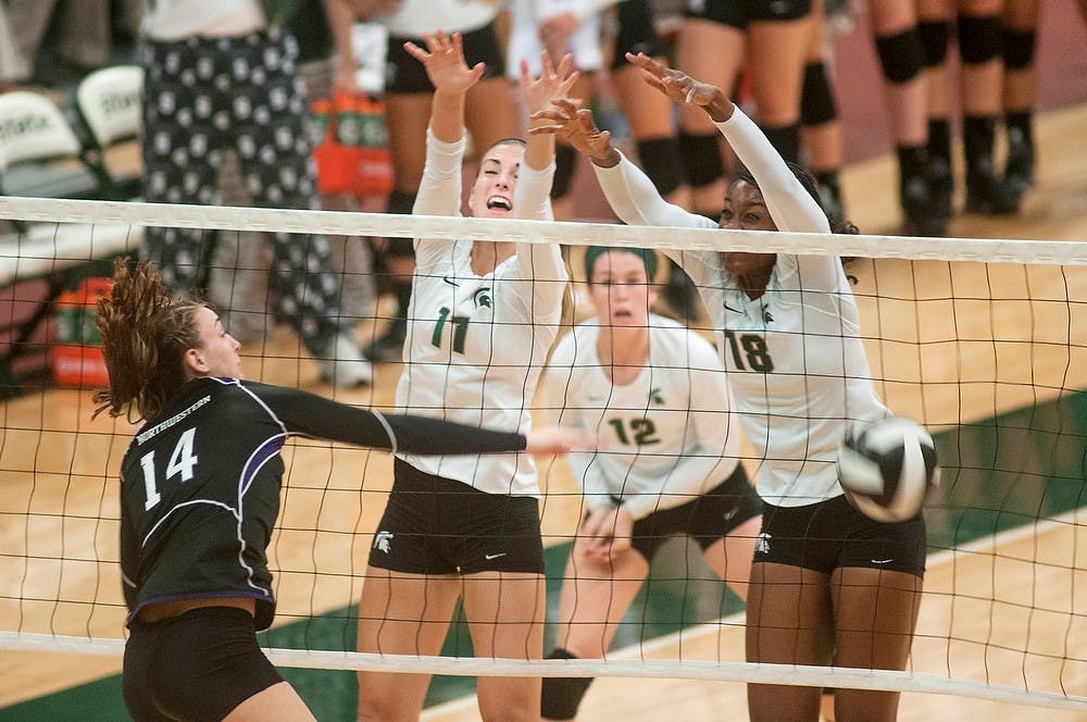 	<p>Freshman Chloe Reinig, left, and senior Alexis Mathews block a shot against Northwestern right-side hitter Katie Dutchman Oct. 5, 2013, at Jenison Field house. <span class="caps">MSU</span> defeated Northwestern in the first three matches. Margaux Forster/The State News</p>