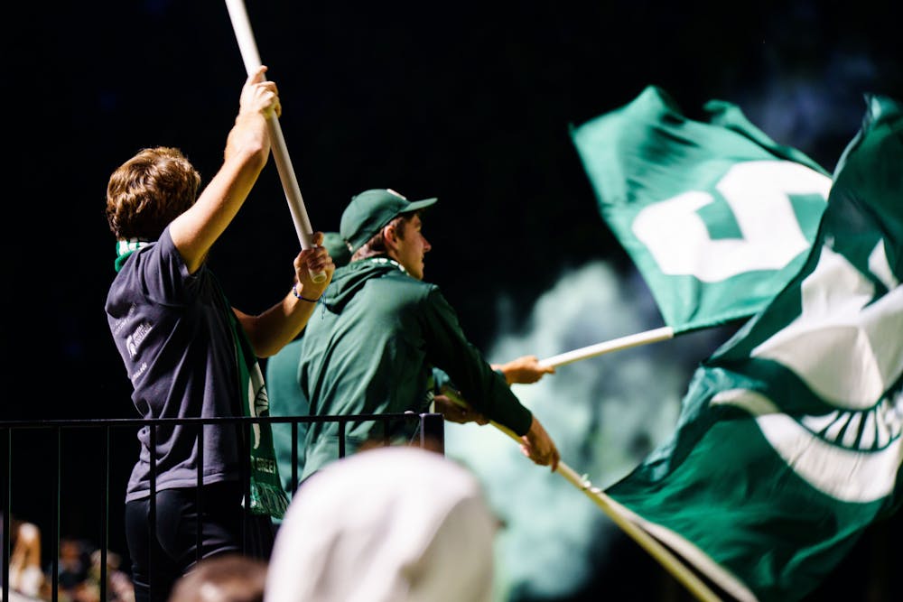 <p>The Michigan State University student section celebrates a goal during an MSU and Chicago State University men's soccer game at DeMartin field on Sept. 12, 2022. The Spartans defeated the Cougars 4-1.</p>