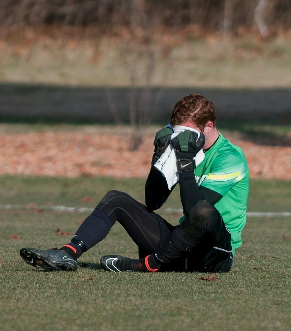 <p>Junior goalkeeper Zach Bennett breaks down at the end of the game against Providence College  on Dec. 6, 2014, at DeMartin Stadium at Old College Field. The Spartans were defeated by the Friars, 2-3. Raymond Williams/The State News</p>