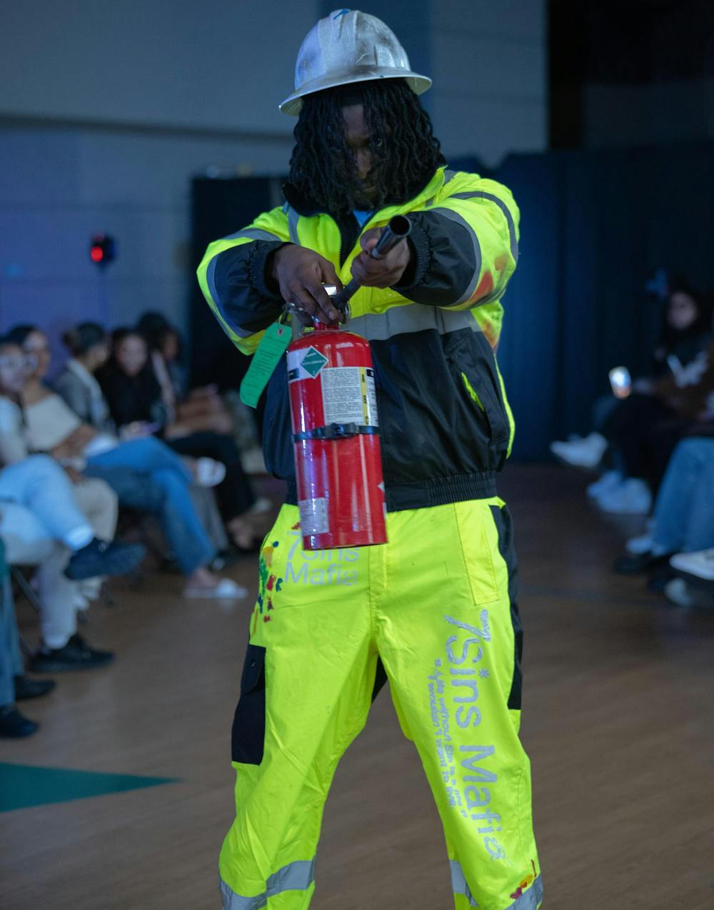 <p>A model poses down the runway in the ballroom of Demonstration Hall wearing clothing brand, 7 Sins Mafia</p>