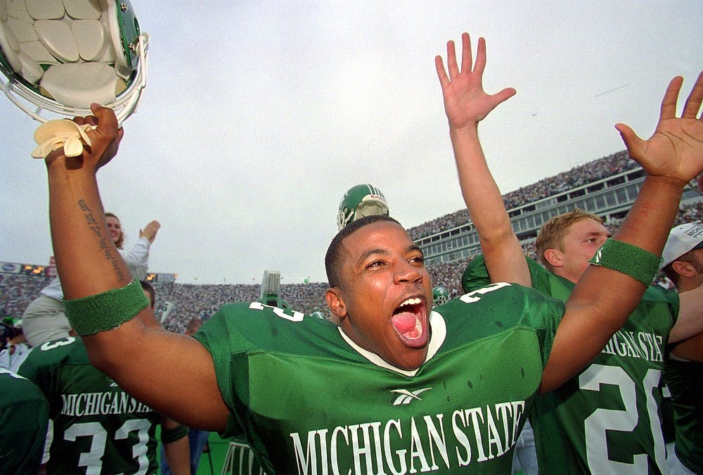 <p>Sophomore tailback Shawn Foster celebrates the Spartan's 34-31 victory over the Wolverines on Oct. 10, 1999, at Spartan Stadium. Cory Morse/The State News</p>