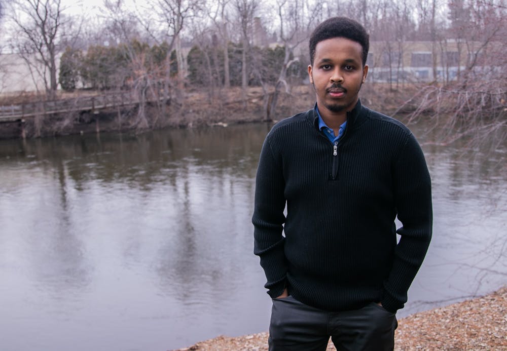 Lansing resident Farhan Sheikh-Omar poses for a portrait in Lansing March 13, 2020. Sheikh-Omar has been a vocal advocate of his friend Uwimana Gasito in his struggle with ELPD in an incident of excessive police force.
