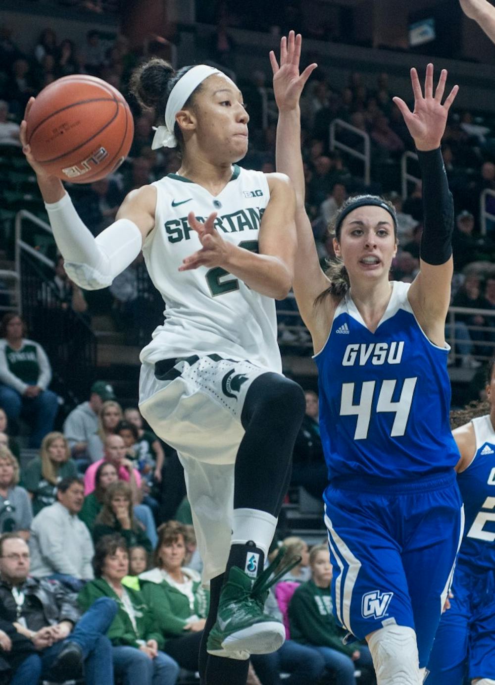 <p>Redshirt sophomore forward Aerial Powers makes a mid air pass while Grand Valley center Korynn Hincka, 44, attempts the block during the game against Grand Valley State on Nov. 9, 2014, at the Breslin Center. The Spartans defeat the Lakers 70-51. Raymond Williams/The State News</p>