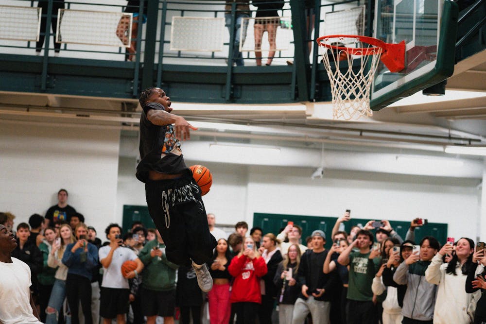Michigan State sophomore forward Coen Carr dunks the ball in front of students at IM East on April 16, 2025. The men's basketball team showed off their skills during pickup runs for students to watch.