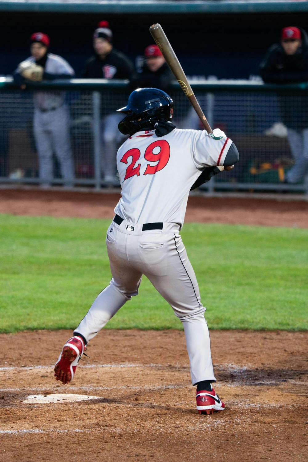 <p>Lansing Lugnuts right fielder Danny Bautista Jr winds up his swing under the lights at Jackson Field during the "Crosstown Showdown" on Wednesday, April 3, 2024. The Lugnuts beat the Spartans 18-0 in this year's annual matchup game.</p>