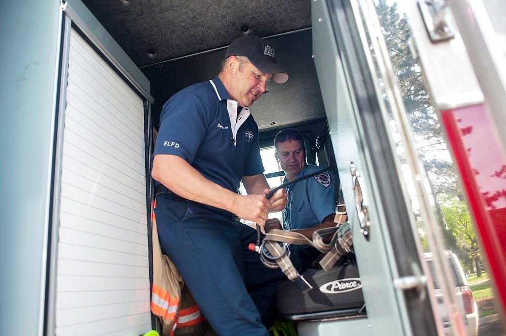 	<p>Firefighters, from left, Bill Sedlacek and Jim Ladiski prepare to head out to another call June 13, 2013, at East Lansing Fire Station #2. Justin Wan/The State News</p>