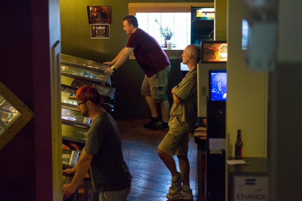 Jackson, Mich. resident Chris Tabaka waits to play his round of pinball on Sept. 13, 2016 at The Avenue Cafe in Lansing. Tabaka has been playing in the Lansing Pinball League since it first started and he has won each tournament season since the league began.