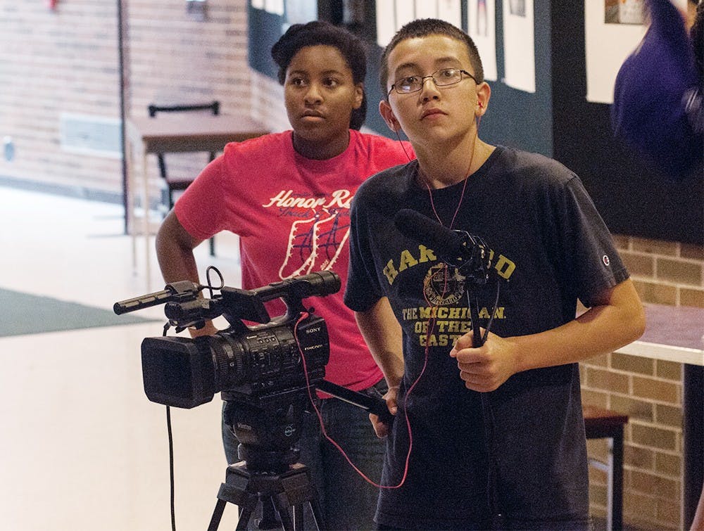 <p>Zarreya Patyton, 13, and Ben Gnodtke, 13, work with MSU Media Summer Camp counselor Nathaniel Wright (not pictured), a fifth year media and information student July 7, 2015, at MSU on their short film. At this summer camp, campers learn how to operate professional video, audio and lighting equipment under the supervision of their counselors, who are MSU students and alumni. Catherine Ferland/The State News</p>