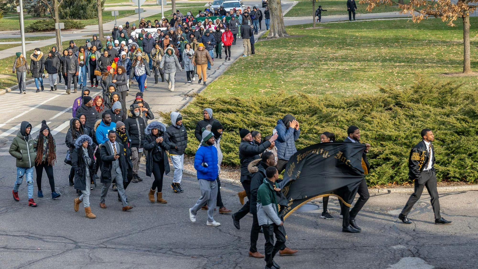 <p>Community members march at MSU's 2023 Dr. Martin Luther King, Jr. Commemorative March from Beaumont Tower. Photo courtesy of MSU by Derrick L. Turner.</p>