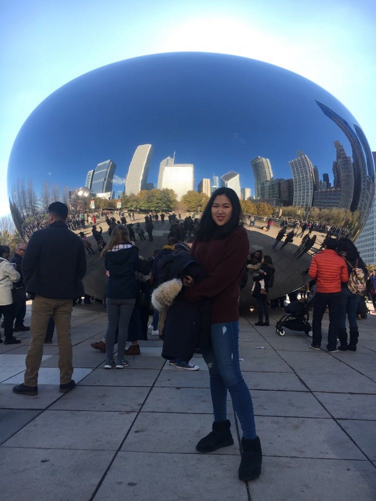 Echo Huan, an MSU junior in the studio arts and finance major from Beijing, China, poses in front of the famous Cloud Gate sculpture on a recent Thanksgiving trip to Chicago. 
Photo courtesy of Echo Huan