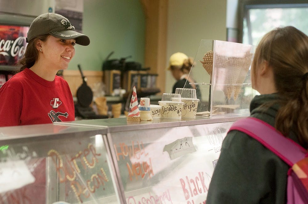 <p>Kinesology freshman Ceci Kieliszewski takes psychology freshman Sydney Rivard's order Sept. 15, 2014, at the Dairy Store in Anthony Hall. Students are able to order ice cream and cheeses that are processed on Michigan State's campus. Aerika Williams/The State News </p>