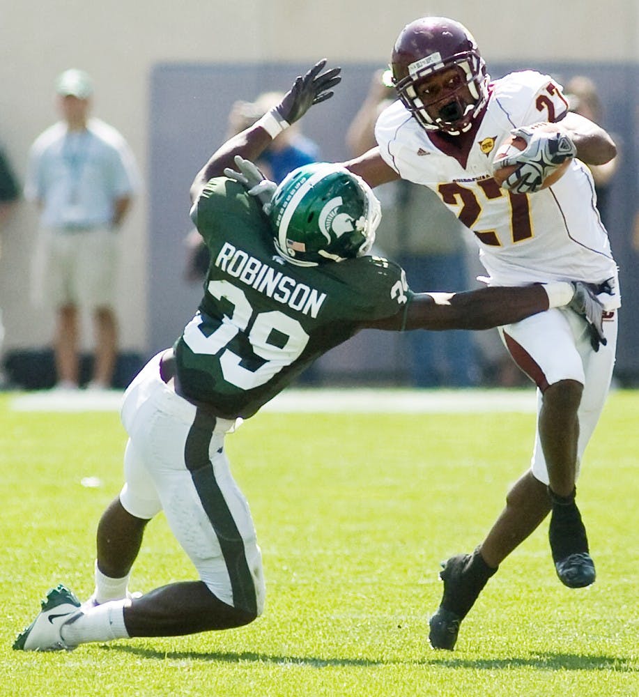 Chippewa wide receiver Antonio Brown stiff-arms then-sophomore free safety Trenton Robinson on Sept. 12, 2009 at Spartan Stadium. State News File Photo