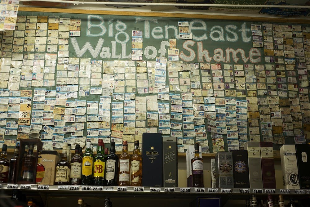 <p>The Wall of Fake ID's February 11, 2015, at the east branch of the Big Ten Party Stores, 1108 E. Grand River Ave, East Lansing. Kennedy Thatch/The State News</p>