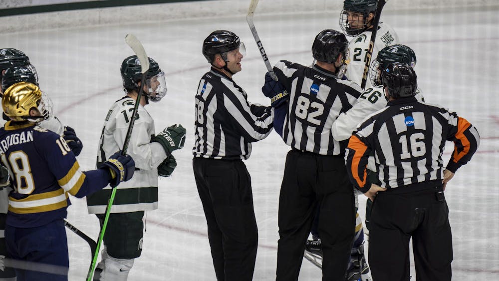 <p>Referees break apart MSU and Notre Dame players as sticks come up at Munn Ice Arena on Nov. 15, 2024. Michigan State took the win 8-3.</p>