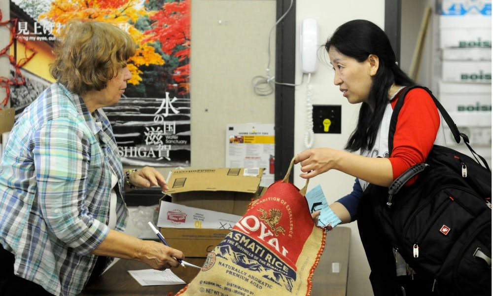 <p>Doctoral student Sun Yanxiang, right, checks out Sept. 17, 2015, at the Lending Center in Spartan Village. The Lending Center is a second hand store used to help international students with home necessities and is closing this spring.</p>