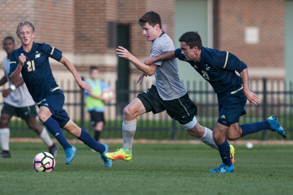 Junior defender Brad Centala (8) dribbles the ball up the field during the game on Oct. 11, 2016 at DeMartin Stadium at Old College Field. The Spartans defeated the Zips, 2-1.