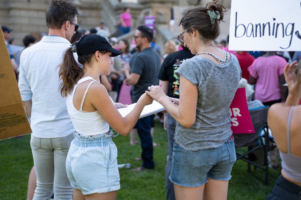 <p>A representative with Planned Parenthood of Michigan gathers petitions for a ballot initiative enshrining abortion rights in Michigan&#x27;s constitution. Supporters of abortion rights gathered at the Capitol on June 24, 2022, after the overturning of Roe v. Wade.</p>