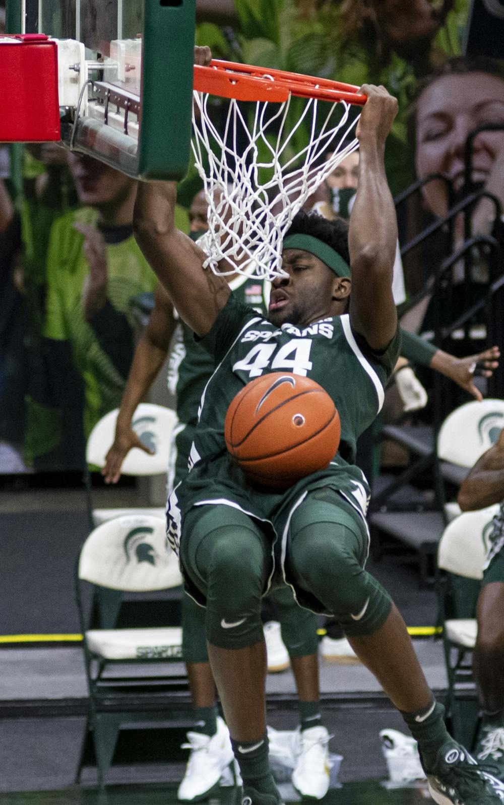 Junior forward Gabe Brown (44) dunks on Oakland's basket during the second half. The Spartans came back after the first half to pull out a 109-91 win on Dec. 13, 2020.
