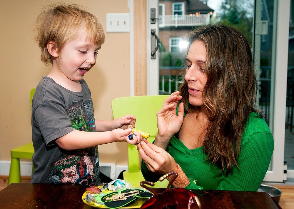 	<p>Four-year-old East Lansing resident Charlie Waller plays with his godmother and Wisconsin resident Carrie Green on Friday morning, Oct. 26, 2012, at the Waller&#8217;s home. Waller was diagnosed with diffuse intrinsic pontine glioma, which is an inoperable brain stem cancer that afflicts mostly young children. Natalie Kolb/The State News</p>