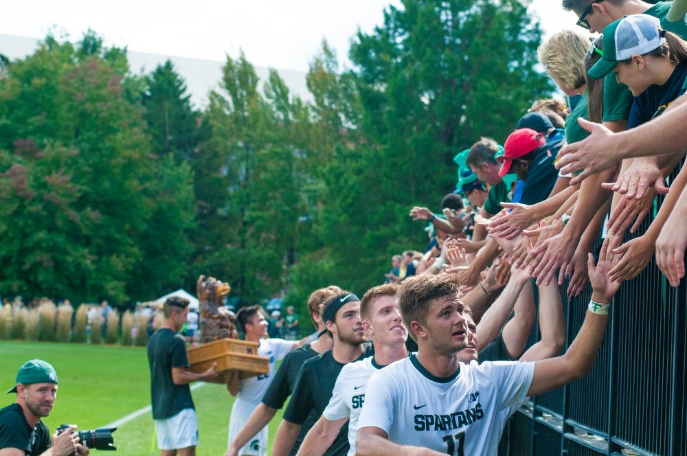 Sophomore forward Ryan Sierakowski (11) leads the team in a line treating the audience on Sept. 18, 2016 at DeMartin Stadium at Old College Field. The Spartans defeated the Michigan Wolverines, 1-0.