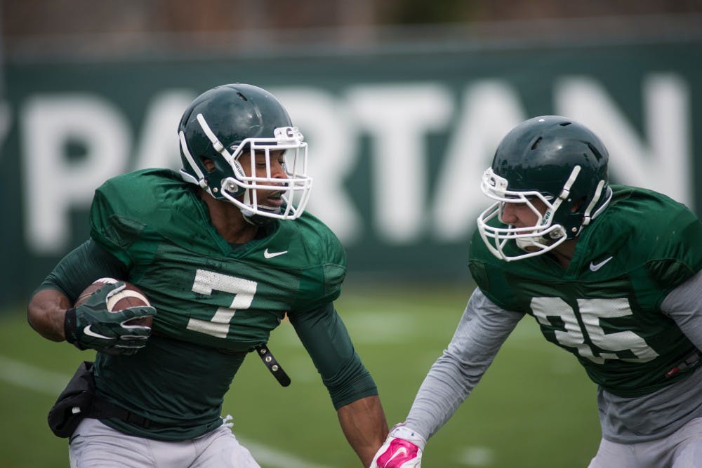 Senior defensive back Demetrious Cox (7) runs with the ball during spring practice on April 19, 2016 at the practice fields behind the Duffy Daugherty Football Building.