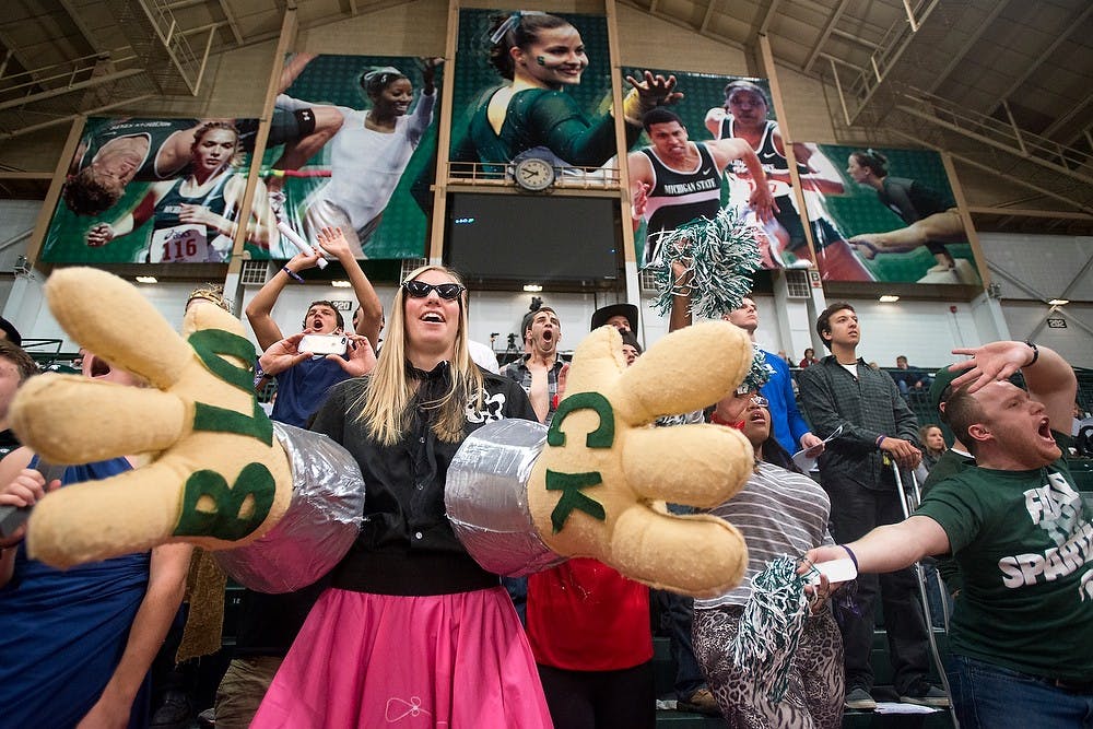 <p>Special education senior and former volleyball player Kelsey Kuipers cheers on the Spartans on Oct. 31, 2014, at Jenison Field House during the game against Illinois. The Spartans lost, 3-1. Julia Nagy/The State News</p>