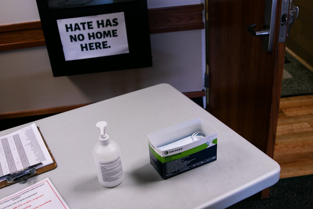 Masks and hand sanitzer sit at the check-in station at Olin Health Center August 24, 2020.