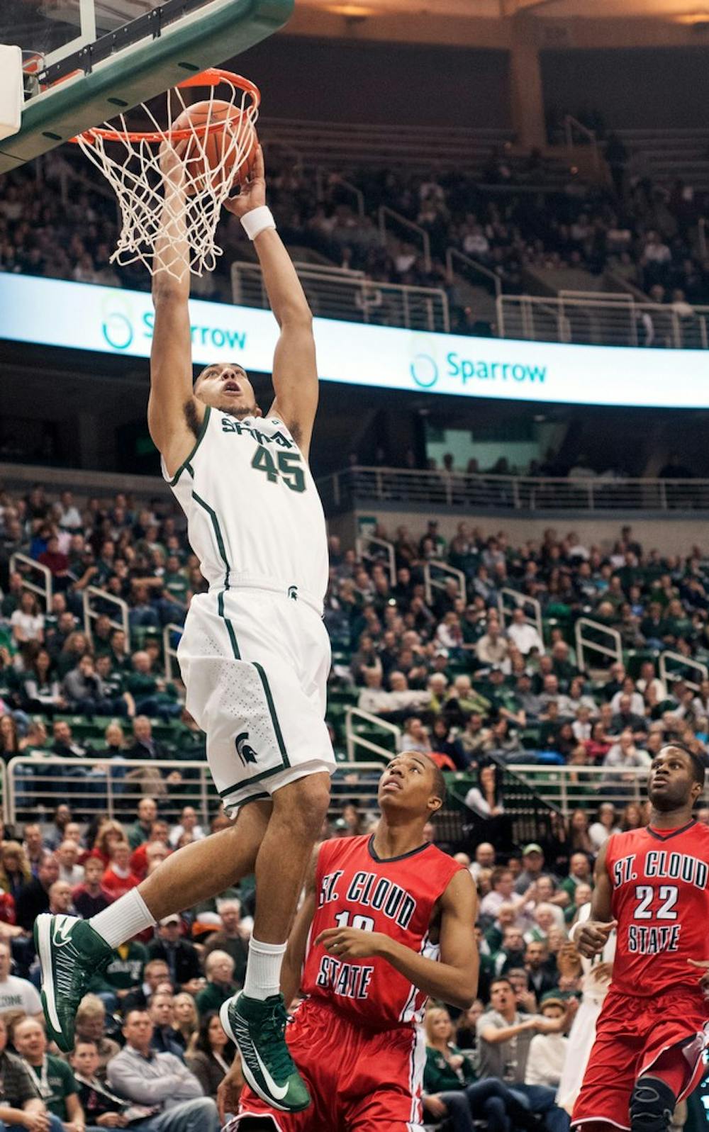 Freshman guard Denzel Valentine jumps for an alley-oop but was unable to score Nov. 2, 2012, at Breslin Center. The Spartans defeated St. Cloud State 62-49 in the second and final exhibition game of the season. Adam Toolin/The State News
