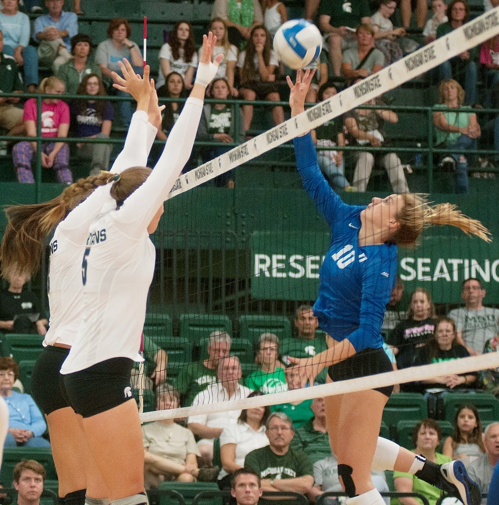 <p>Freshman outside hitter Holly Toliver and redshirt freshman middle blocker Megan Tompkins attempt to block Duke middle blocker Anna Kropf on Sept. 6, 2014 at Jenison Fieldhouse during a game against Duke University. The Blue Devils defeated the Spartans, 3-2. Aerika Williams/The State News </p>