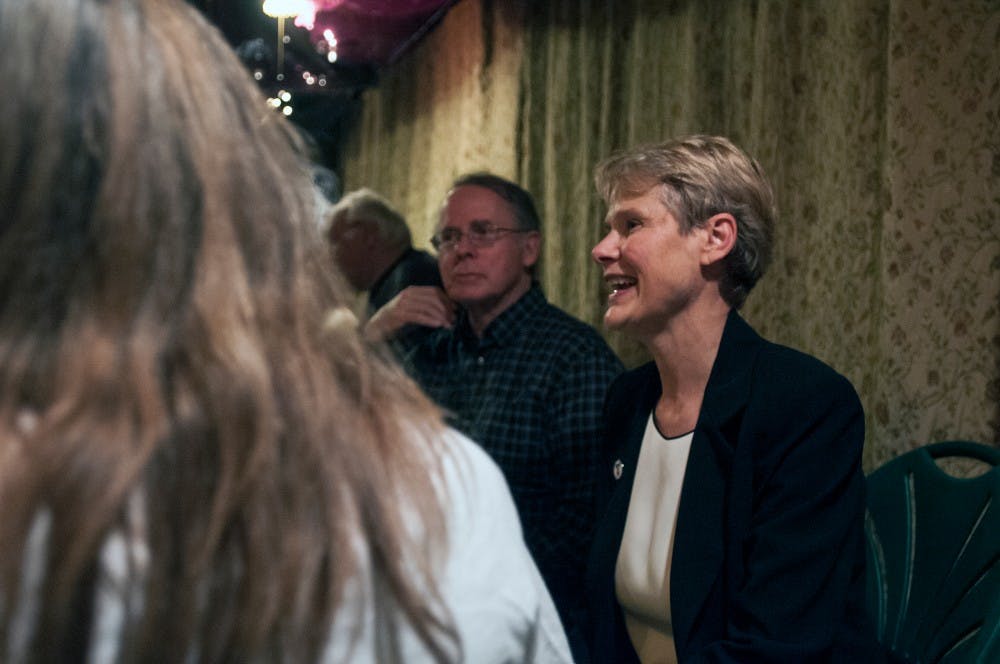 Democratic prosecutor candidate Carol Siemon, right, discusses voting results with guests during an election watch party on Nov. 8, 2016 in Okemos, Mich. 