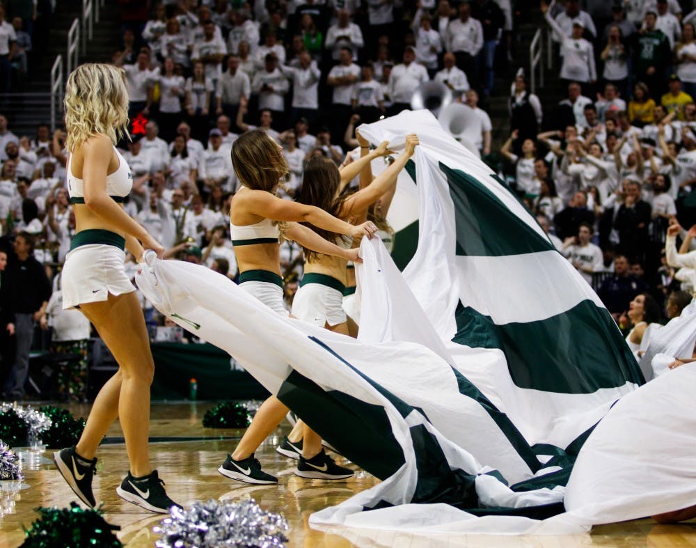 MSU cheerleaders wave a banner during the game against Michigan at Breslin Center March 9, 2019. The Spartans defeated the Wolverines, 75-63.