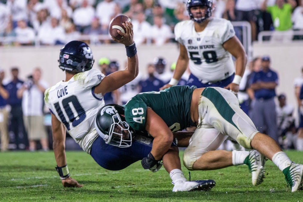 Junior defensive end Kenny Willekes (48) sacks Utah State quarterback Jordan Love (10) late in the game against Utah State on Aug. 31 at Spartan Stadium. The Spartans defeated the Aggies, 38-31.