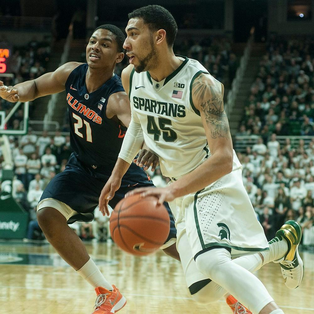 <p>Junior guard Denzel Valentine maneuvers around Illinois guard Malcolm Hill Feb. 7, 2015, during the game at Breslin Center. The Spartans were defeated by the Fighting Illini, 59-54. Erin Hampton/The State News</p>