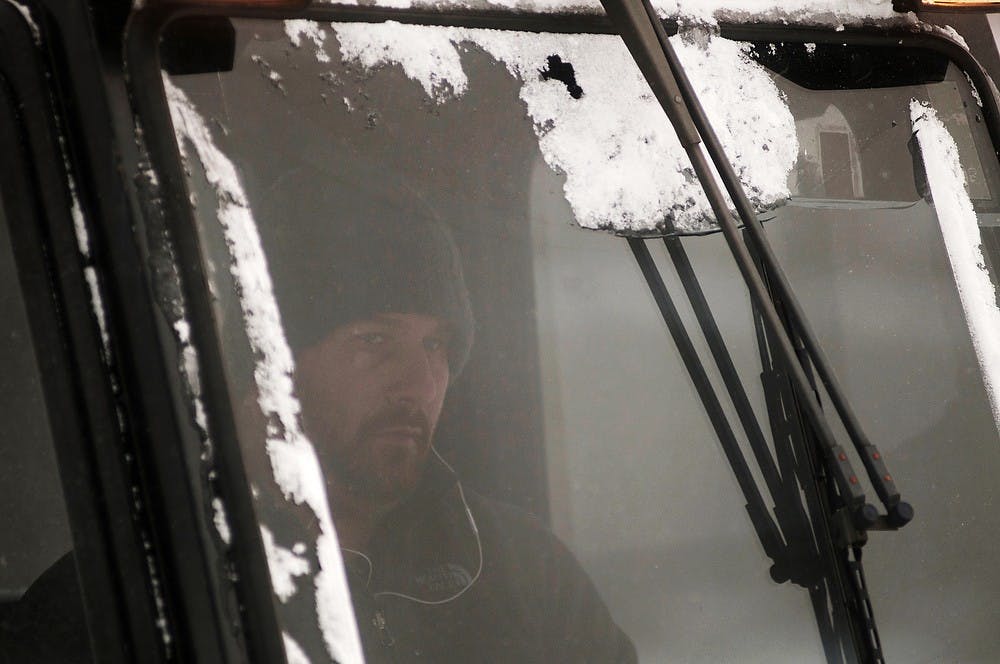 	<p>Landscape Services employee Nathan Franklin clears snow off sidewalks on Jan. 6, 2014, in front of the Human Ecology building. According to The Weather Channel, East Lansing received an estimated 7.7 inches of snow in the last 24 hours. Christina Strong/The State News</p>