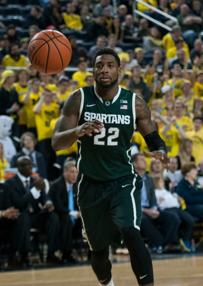 <p>Senior guard/forward Branden Dawson goes for the ball Feb. 17, 2015, during the game against Michigan at Crisler Center in Ann Arbor. The Spartans defeated the Wolverines, 80-67. Hannah Levy/The State News</p>