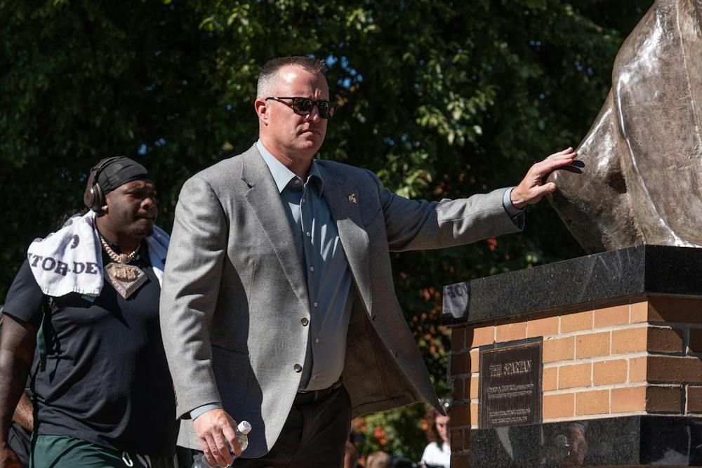 <p>Michigan State head coach Pat Fitzgerald touches the Spartan statue during the team’s pregame walk before the Spartans’ game against Nebraska at Spartan Stadium in East Lansing, Mich., on Saturday, Sept. 26, 2026.</p>