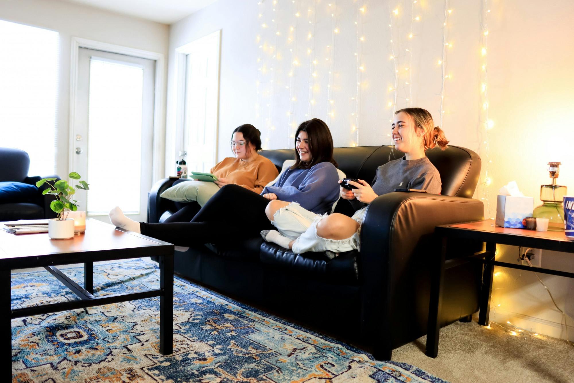 <p>Sophomore roommates Gabriella Lopez and Bella Johnson watch their roommate Jenna Drew play video games. Taken on Feb. 14, 2022.</p>