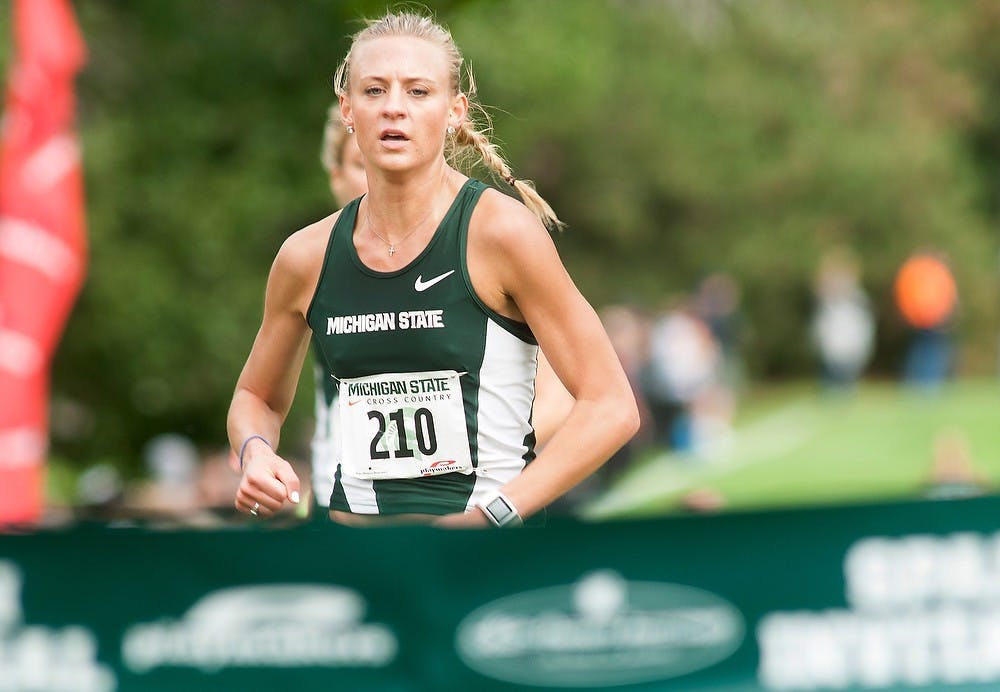 <p>Senior Leah O'Connor reaches the finish line the Spartan Invitational on Sept. 12, 2014, at Forest Akers East Golf Course, 2280 South Harrison Road, in East Lansing, Mich.  O'Connor finished first with a time of 21:03. Raymond Williams/The State News</p>