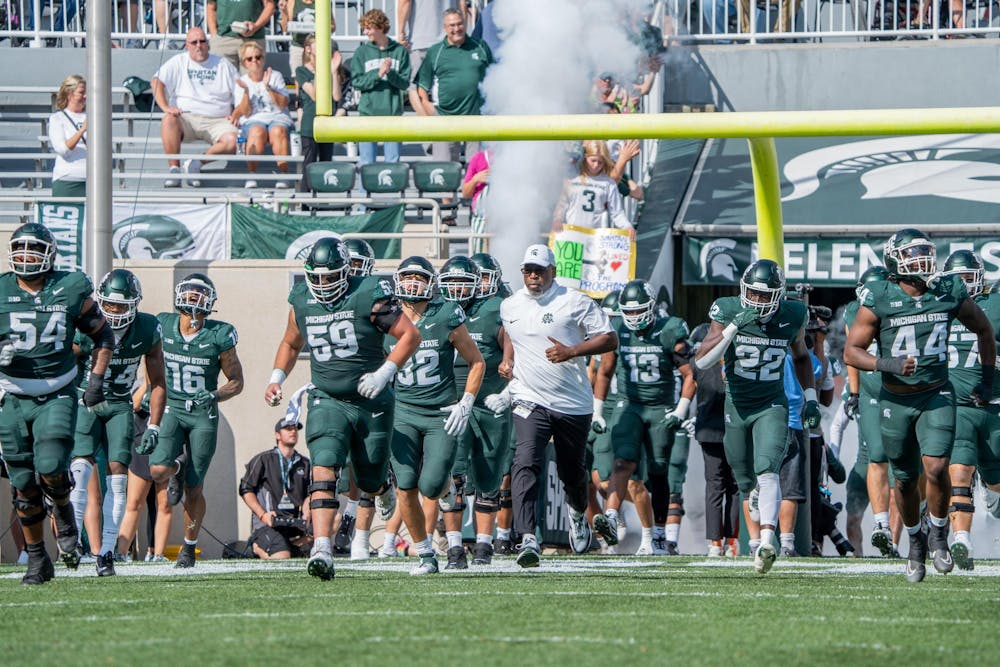 <p>MSU acting head coach Harlon T. Barnett runs out onto the field with his team as the game against Maryland starts at Spartan Stadium on Sept. 23, 2023. The Spartans ultimately lost to the Terrapins 31-9.</p>