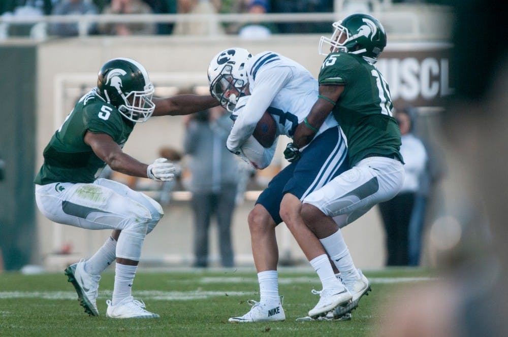 Sophomore cornerback Tyson Smith (15) wraps around Brigham Young wide receiver Colby Pearson (3) during the game against Brigham Young University on Oct. 8, 2016 at Spartan Stadium. The Spartans were defeated by the Cougars, 31-14.