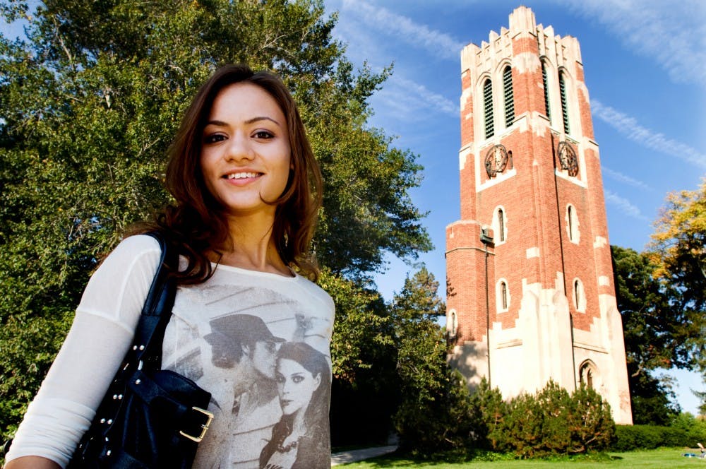 Advertisement sophomore Nailya Maxyutova, who is also on the executive board of the International Student Association, poses in front of Beaumont Tower Wednesday afternoon. Originally from Kazakhstan, Maxyutova now represents a growing sector of MSU students who came from aboard. Justin Wan/The State News