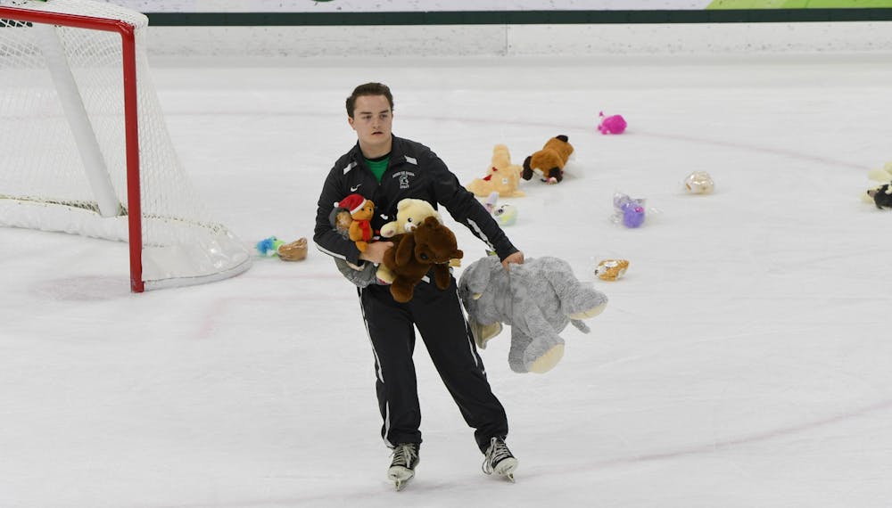 Fans threw out stuffed animals for a charity event during the game against Wisconsin at the Munn Ice Arena on December 6, 2019. The Spartans defeated the Badgers 3-0.